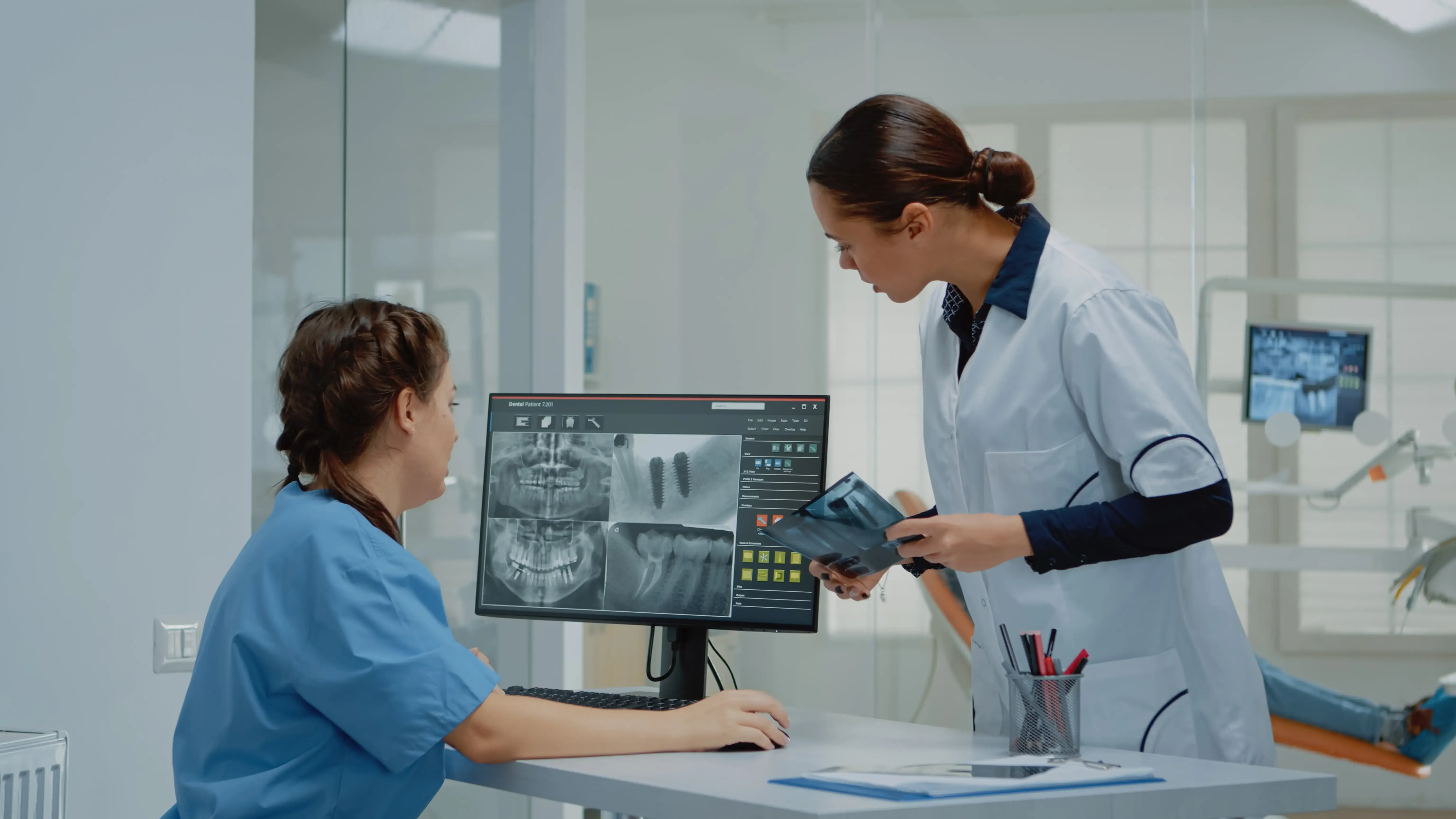 dentist-holding-dentition-x-ray-scan-comparing-radiography.webp